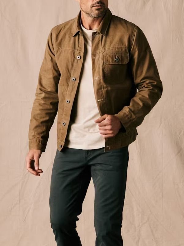 Classic field jacket worn over a button-down shirt with tailored trousers, showcasing smart-casual elegance.
