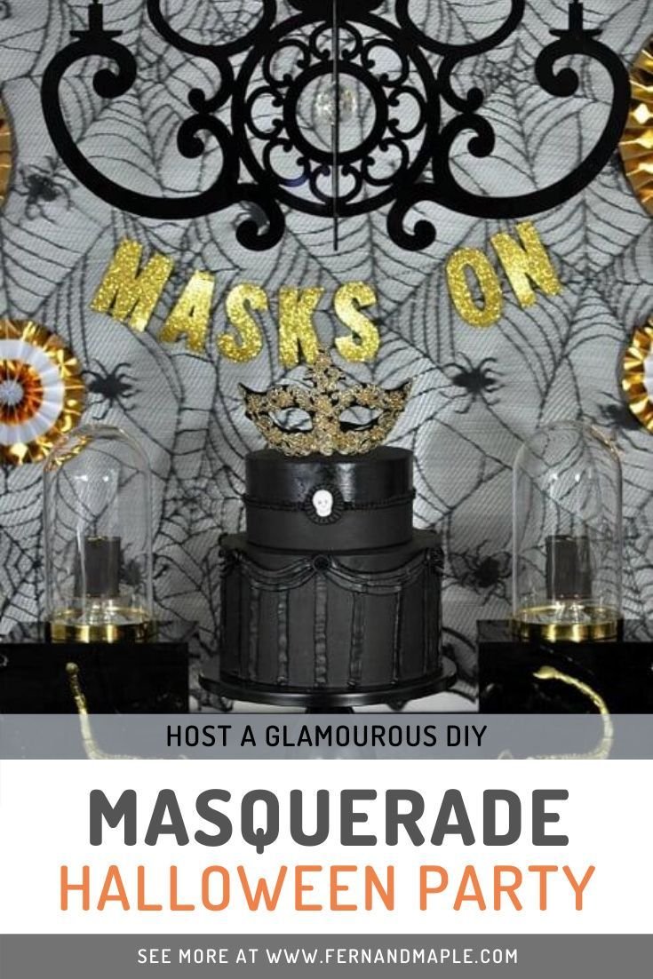 Masqurrade decor table setting with feathers and golden masks
