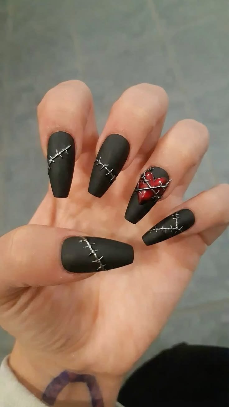 Simple gothic coffin nails in matte black with a single, understated silver accent on one finger.