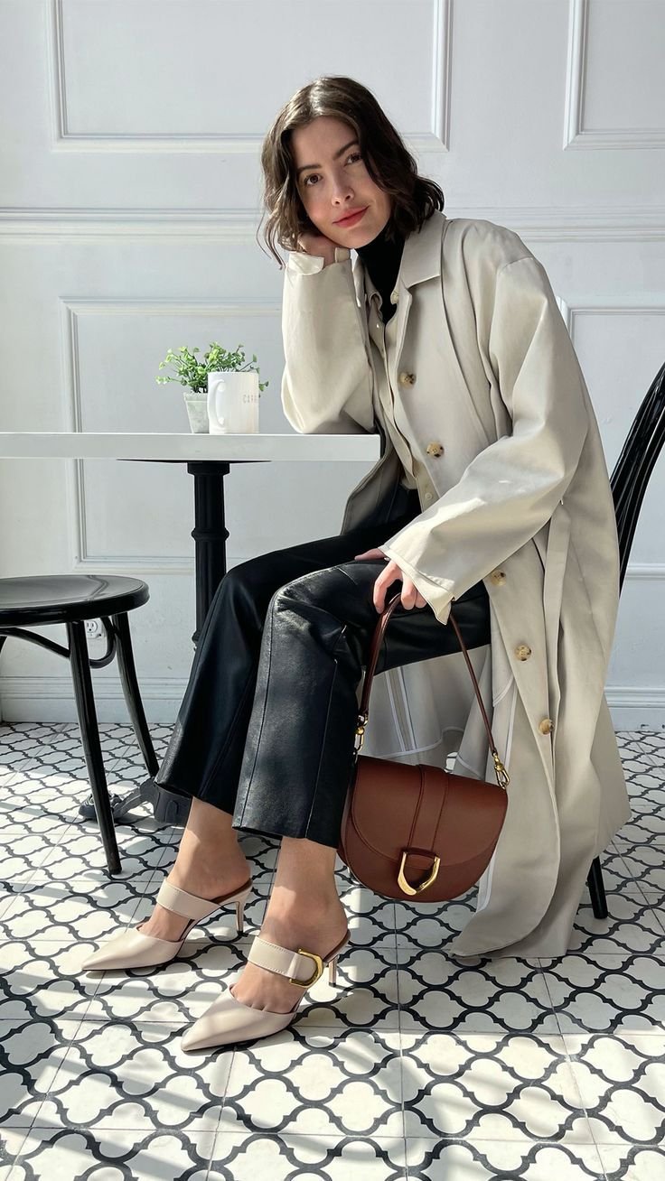 Man in a classic blazer and jeans carries a traditional leather satchel bag.