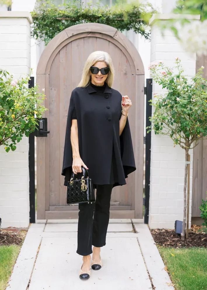 Plus-size cape outfit styled elegantly with dark clothing for a flattering silhouette.