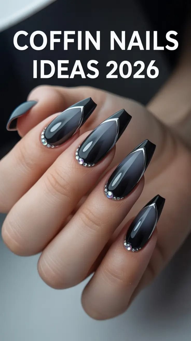 Matte black gothic coffin nails featuring glossy spiderweb designs and a prominent central gem.