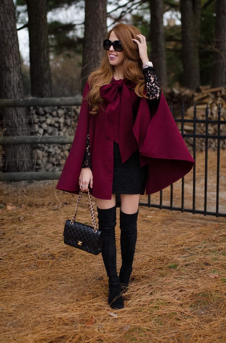 Luxurious formal cape in deep red, draped elegantly over an evening gown.