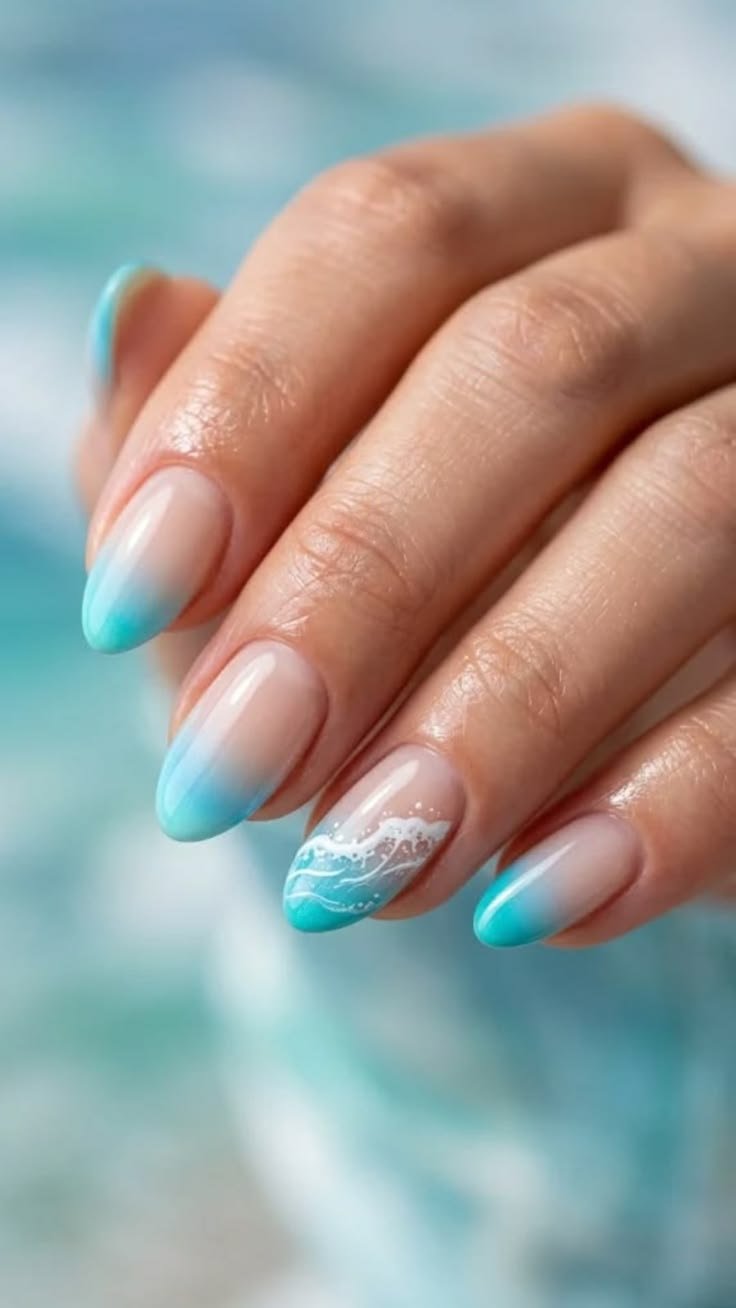Sea inspired nails featuring holographic glitter as ocean foam