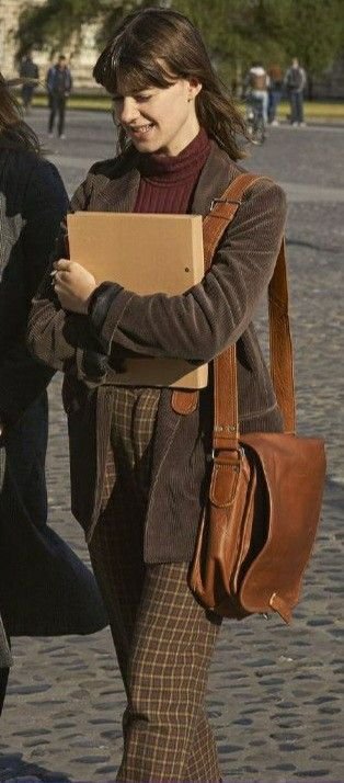 Student carries a functional satchel bag filled with books, blending style with utility.