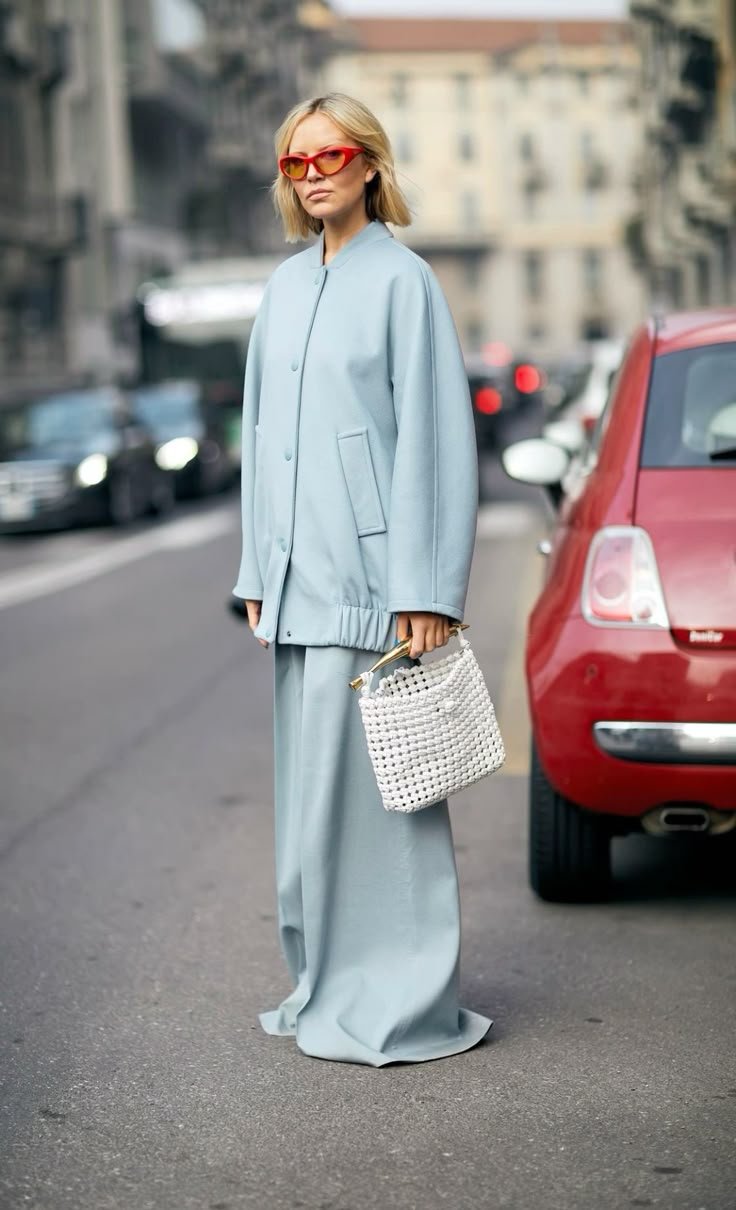 A pair of elegant nude heels positioned next to an icy blue dress, illustrating ideal footwear choices for formal wear.