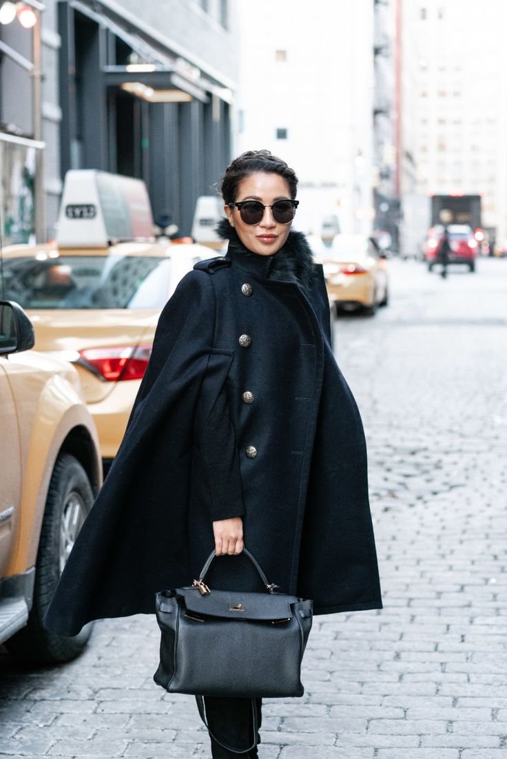 Lightweight summer cape in white, styled for a breezy and elegant warm-weather look.