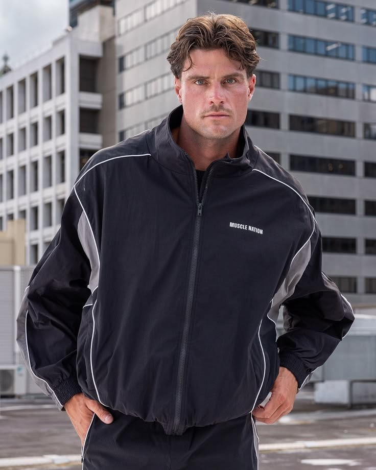 Man in a stylish high collar jacket paired with a sophisticated outfit
