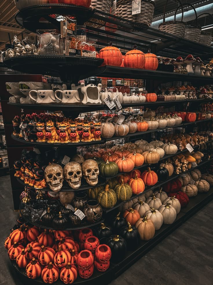 Elegant table setting for a sophisticated halloween aesthetic party with dark candles and florals