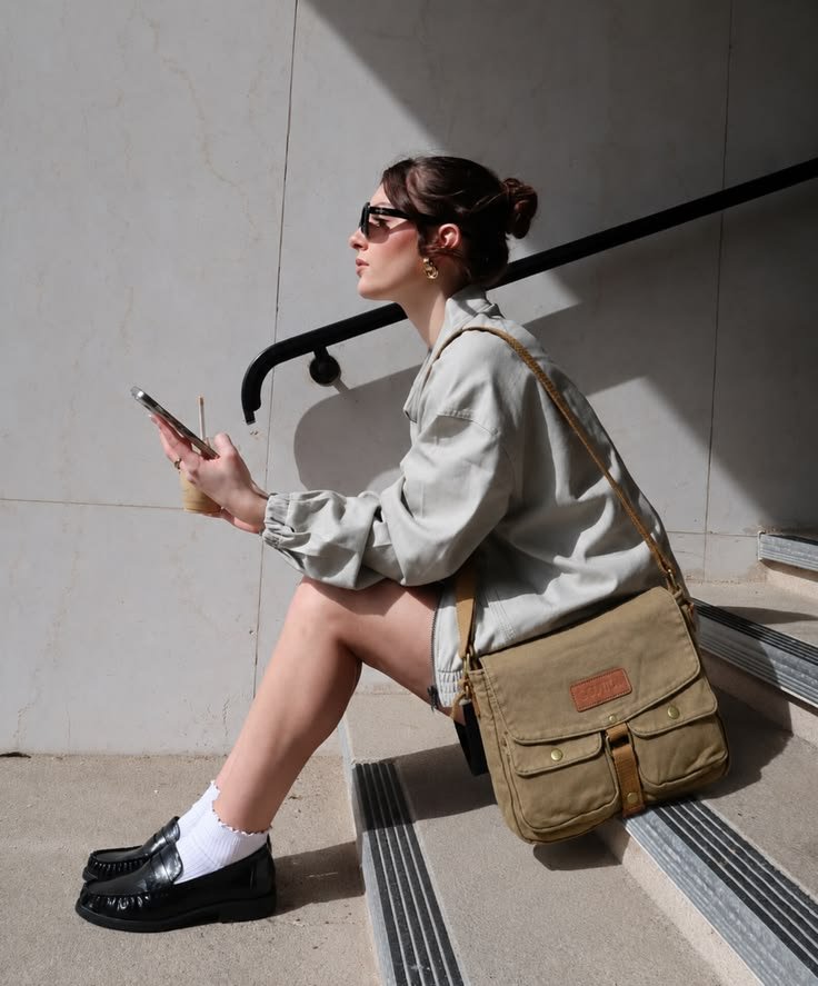 Minimalist outfit featuring a clean-lined satchel bag, emphasizing simple elegance.