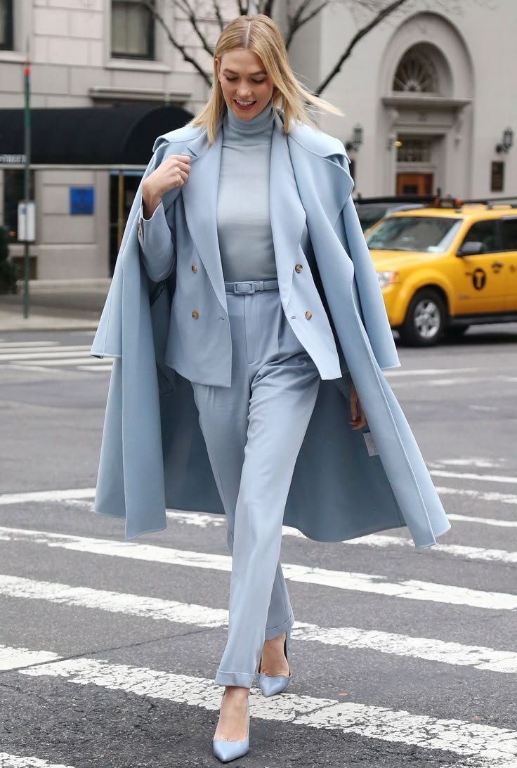 A model with subtle, natural makeup complementing her icy blue attire, highlighting harmonious beauty choices.