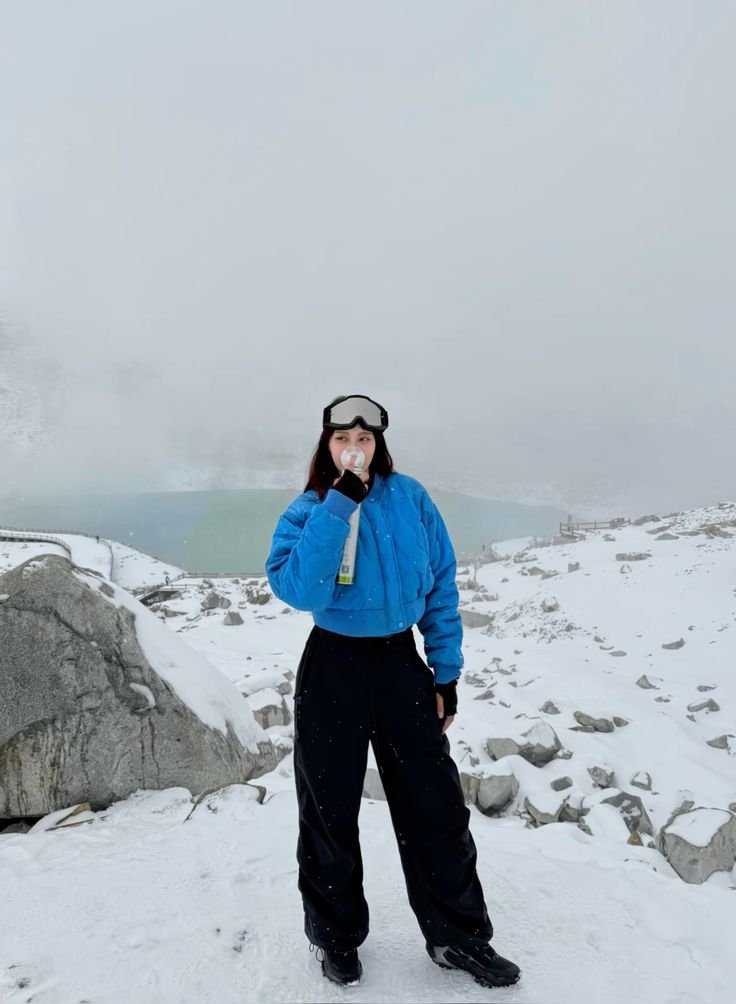 Person wearing multiple layers of light-colored clothing, demonstrating effective layering for cool-toned outfits.
