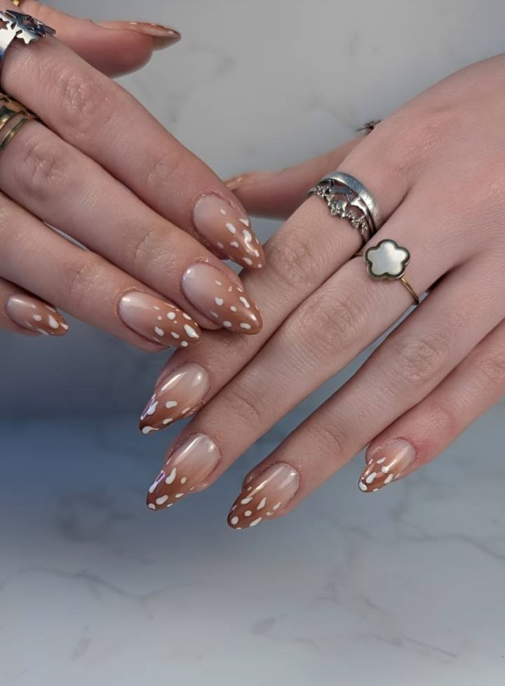 Minimalist deer naihs displaying fine line antler silhouettes on sheer milky white nails
