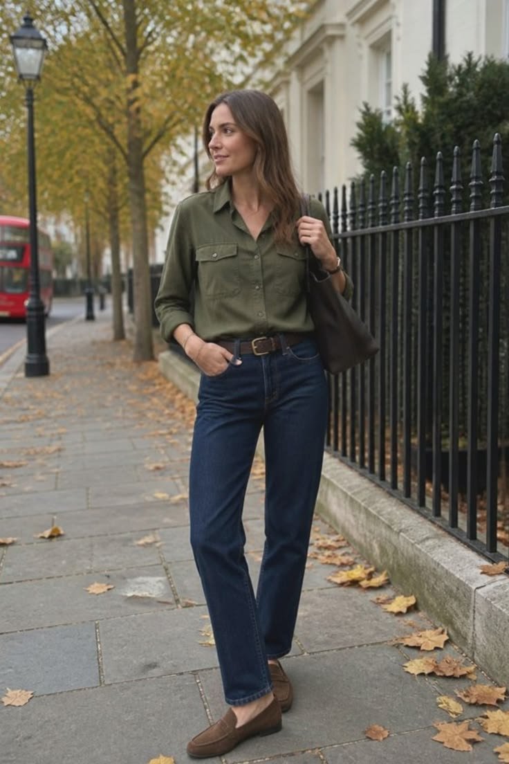 Woman wearing a classic olive green utility shirt outfit, paired with dark pants and simple accessories.