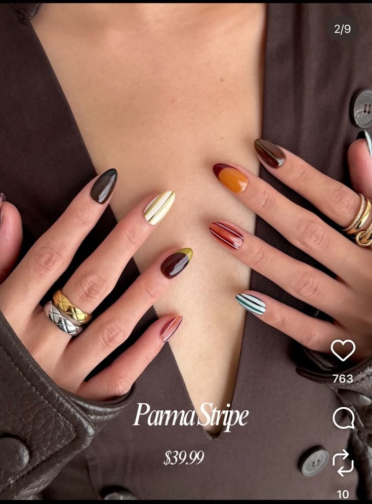 Mixed media nail art featuring embedded pearl embellishments and metallic charms