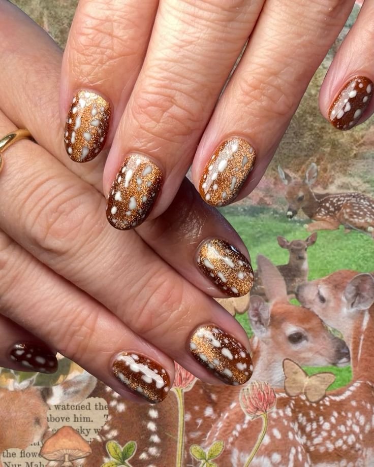 Warm autumn deer naihs manicure combining burnt orange, espresso, and fawn motifs
