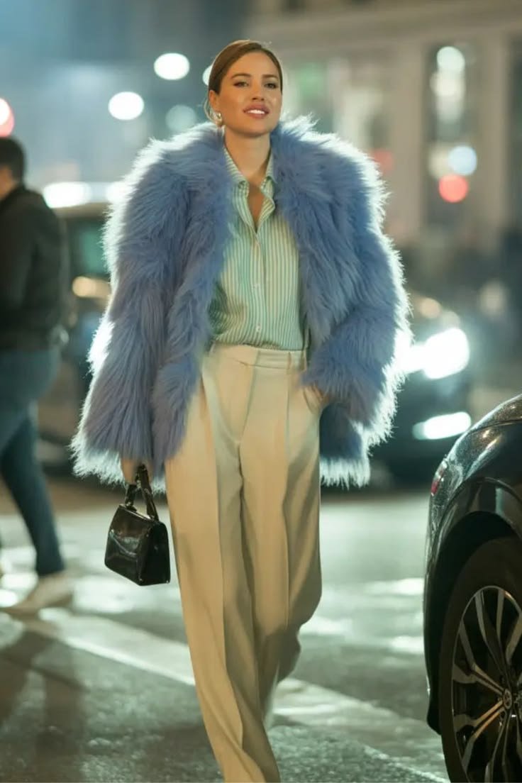 A model wearing a stunning monochromatic icy blue outfit, featuring a textured top and flowing skirt, exuding elegance.