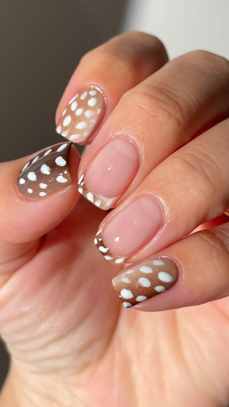 Cute deer naihs design showcasing cartoon doe faces on short rounded nails