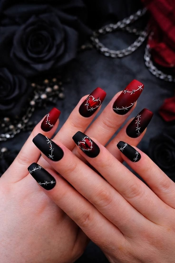 Elegant gothic coffin nails with a glossy black base, accented by delicate silver chains and charms.
