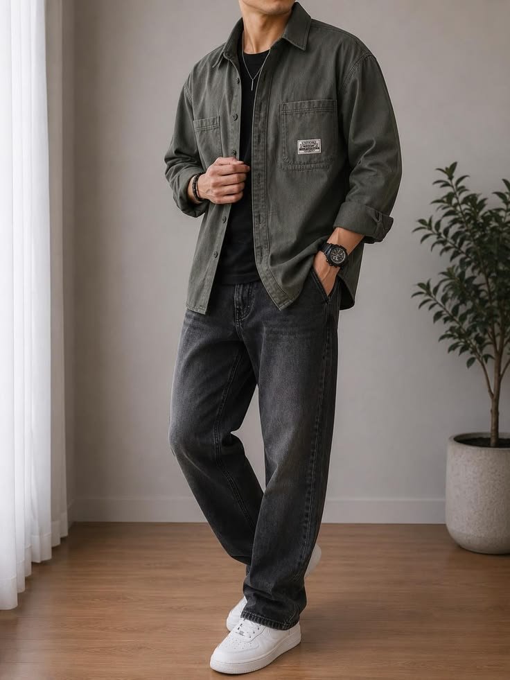 Layered utility shirt outfit featuring the shirt open over a t-shirt, with jeans and boots.